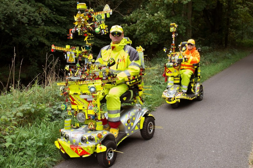 A Dutch man and his mother take no chances with safety while navigating traffic with their extremely visible fluorescent scoot mobiles, equipped with a large amount and variety of horns, bells, claxons and sirens in Wassenaar, Netherlands. The couple, who dress in fluorescent safety suits and live by the motto 