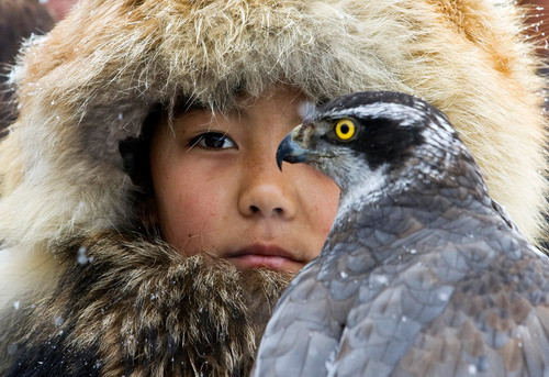 A hunter holds his hawk during an annual hunting competition in Chengelsy Gorge, some 150 km (93 miles) east of Almaty, Kazakhstan on December 5, 2009. (REUTERS/Shamil Zhumatov)