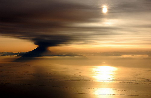 An eruption of Mt. Redoubt seen at sunset from the cockpit of a DC-6 flying over Cook Inlet near Anchorage, Alaska on March 31, 2009. Photograph kindly provided by Bryan Mulder - pilot and photographer. (© Bryan Mulder)