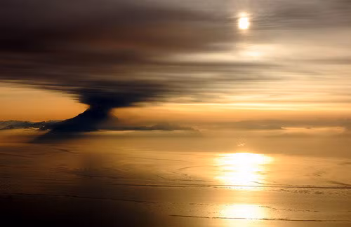 An eruption of Mt. Redoubt seen at sunset from the cockpit of a DC-6 flying over Cook Inlet near Anchorage, Alaska on March 31, 2009. Photograph kindly provided by Bryan Mulder - pilot and photographer. (© Bryan Mulder)