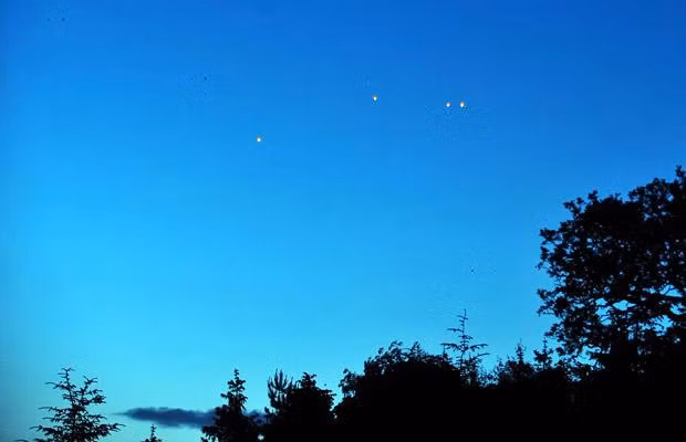 Unidentified flying ojects lighting up skies above Ullswater near Penrith in Cumbria. The orange objects were spotted by campers at Park Foot campsite in the Lake District around 11pm