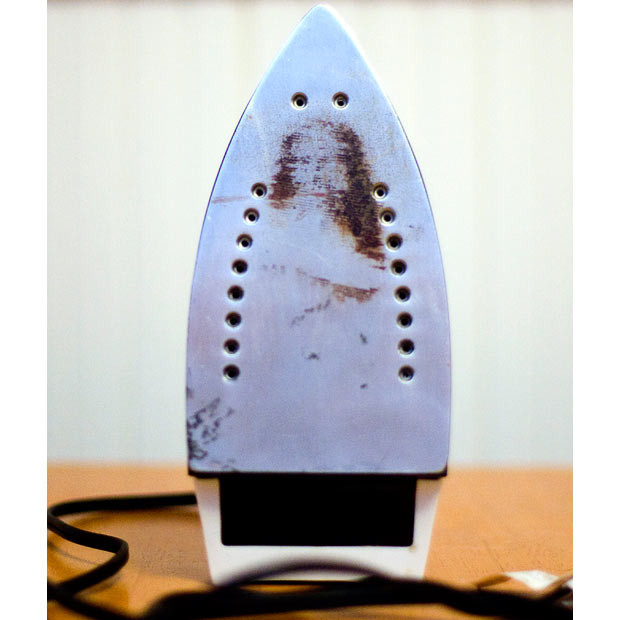 Residue in the shape of an image of Jesus Christ is seen on the bottom of an electric iron at the home of Mary Jo Coady, in Methuen, Massachusetts. Coady says the image has reassured her that 