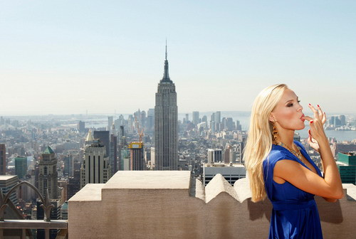 Miss USA, Kristen Dalton, applies lipstick while posing for photographers on the 