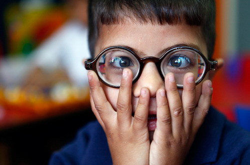 Wadee Daoud, a five-year-old visually impaired Palestinian boy, reacts to light after a teacher opened the window blinds in his classroom at the Helen Keller Center for blind and visually impaired children in the East Jerusalem neighborhood of Beit Hanina September 10, 2009. The Center was founded as a home for blind girls by English missionary, Mary Lovell, in the 1890s. (REUTERS/Yannis Behrakis)
