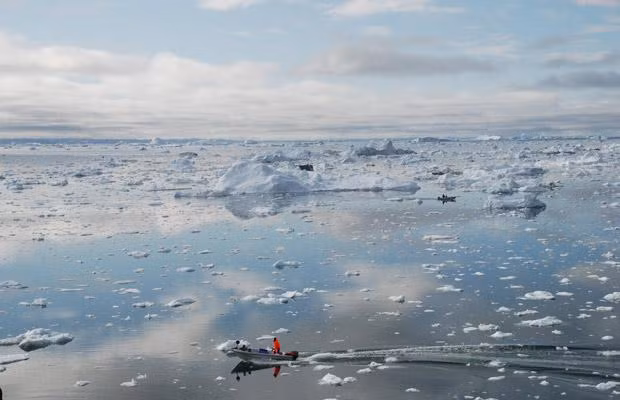 A fisherman sails on the Ice Fjord of Ilulissat, Greenland on July 3, 2009. The glacier, which has become a symbol of climate change, lost 94 square kilometres of surface area between 2001 and 2005 due to global warming