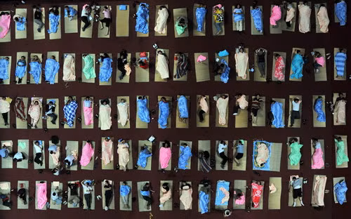 Chinese parents gather to sleep at an auditorium after they accompanied their children to a university to start their first semester in Wuhan, central China’s Hubei province on September 7, 2009. (STR/AFP/Getty Images)
