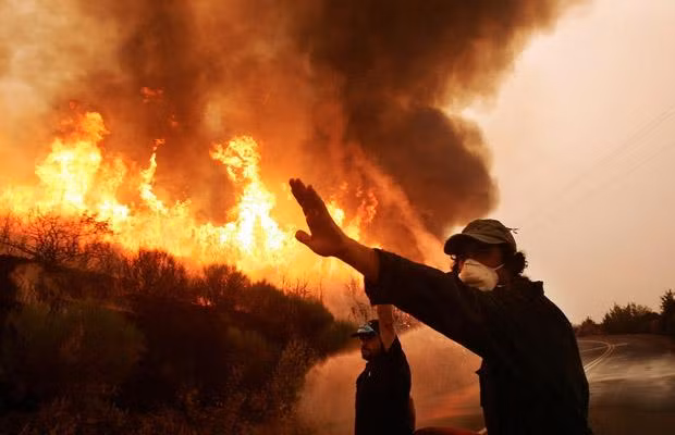 Firemen battle a fire near the village of Andritsena on the Peloponnese peninsula, 27 August 2007