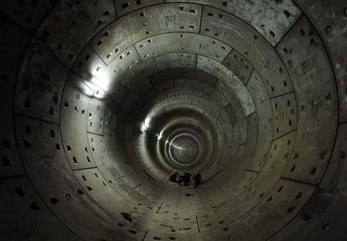 Delhi Metro Rail Corporation (DMRC) employees work on the last-pre cast segments (rings) of the Phase-II underground tunneling project between neighborhoods Jangpura and Lajpat Nagar in New Delhi on October 12, 2009, part of a larger project to have metro lines to cover the entire National Capital Region for the 2010 Commonwealth Games (MANAN VATSYAYANA/AFP/Getty Images)
