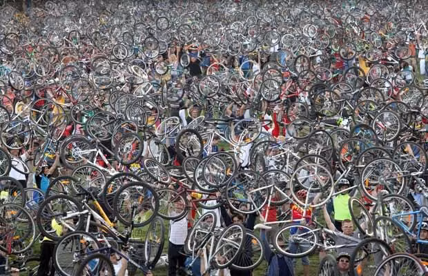 Hungarian cyclists hold up their bikes at Varosliget gardens in Budapest on April 19, 2009 during an environmental demonstration. The Budapest ’Critical Mass’ is becoming one of the most important with more than 30,000 participants