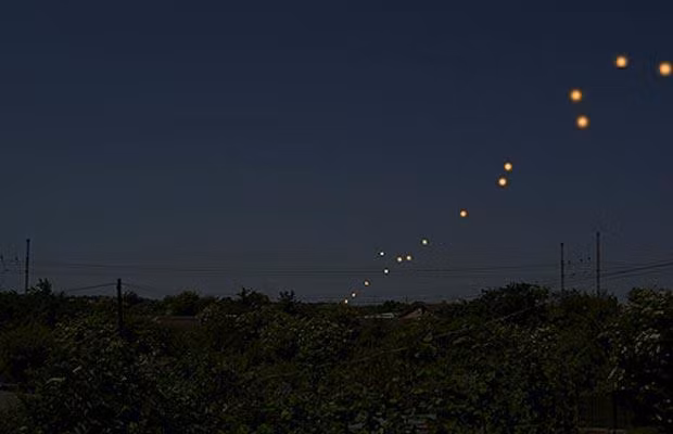 A number of people claimed to have seen UFOs in Cambridgeshire after dazzling orange lights flashed across the night sky
