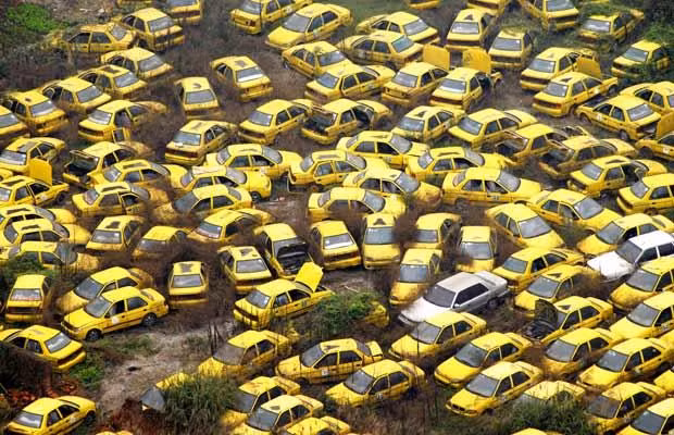 Thousands of scrapped taxis are abandoned at a yard in the centre of Chongqing city on March 4, 2009. Traffic congestion and pollution have worsened dramatically as more people can afford to own their own cars