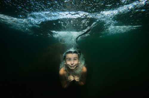 A girl dives in a lake 100 km (62 miles) west of St. Petersburg, Russia, in this Aug. 7, 2009 photo. (AP Photo/Dmitry Lovetsky