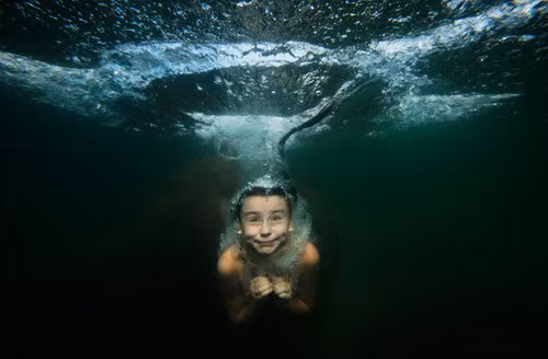 A girl dives in a lake 100 km (62 miles) west of St. Petersburg, Russia, in this Aug. 7, 2009 photo. (AP Photo/Dmitry Lovetsky