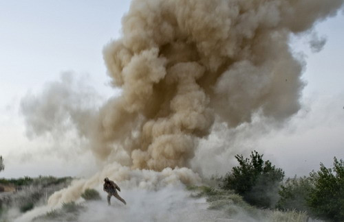 A US Marine of 2nd Marine Expeditionary Brigade runs to safety moments after an IED blast in Garmsir district of Helmand Province in Afghanistan on July 13, 2009. Two US Marine soldiers were killed when the explosion occurred as they tried to clear a route into the Taliban heartland of southern Helmand province. (MANPREET ROMANA/AFP/Getty Images)