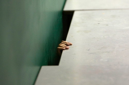 An Israeli boy takes cover under a desk in a bomb shelter at a school in Jerusalem June 2, 2009, after a siren was sounded during a nationwide civil defense drill simulating a rocket attack. (REUTERS/Ronen Zvulun)