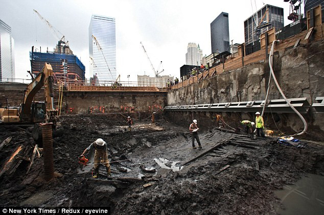Ship-shape: Archaeologists work on the remains of an 18th century ship found buried at the site of the World Trade Centre yesterday