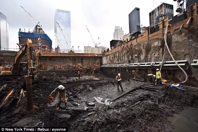 Ship-shape: Archaeologists work on the remains of an 18th century ship found buried at the site of the World Trade Centre yesterday