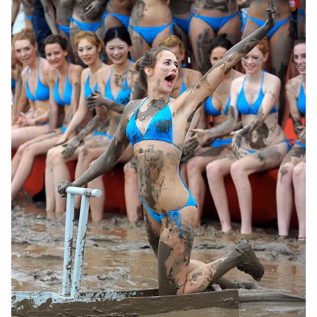 Contestants play in mud during the Miss Ocean Contest in Zhoushan, Zhejiang Province, China