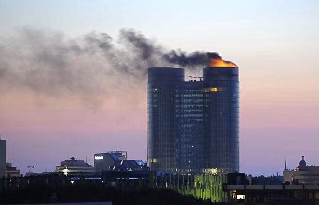 A fire rages on the top floors of a major Dutch bank’s prestigious new headquarters while it was still under construction. No injuries were reported in the blaze that broke out at the top of one of a pair of 27-floor, 105-metre (345-foot) oval towers that are to be the new headquarters for Rabobank in Utrecht. The cause is still unknown, though the the area where the fire broke out houses elevator and electrical equipment