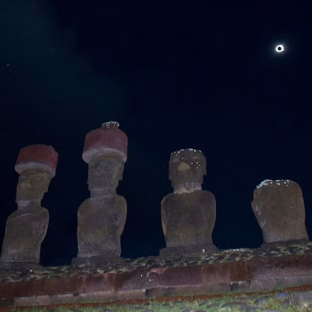 A row of Moai - 3,000-year-old large stone statues - are seen during a total solar eclipse on Easter Island