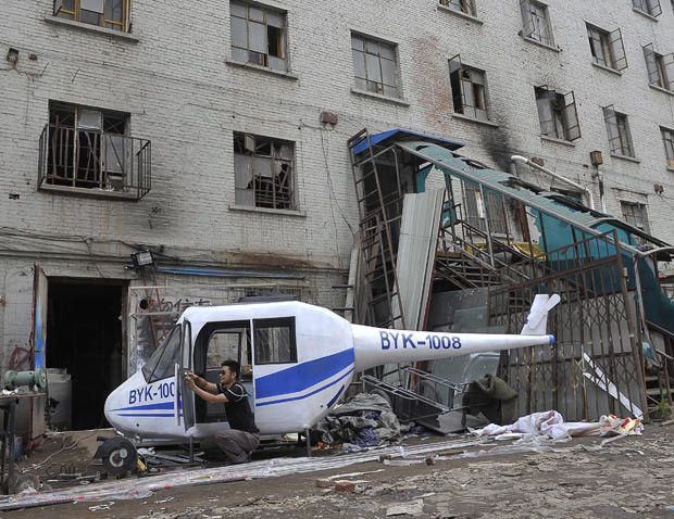 Gao Hanjie puts the finishing touches to his homemade helicopter in Shenyang, northeast China. Gao spent two months making the 350kg, three-metre-long aircraft and will soon be looking for a suitable open space for the first test flight