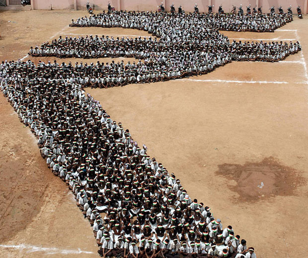 Indian schoolchildren form the shape of the new symbol for the Rupee at a school in Chennai. India unveiled a symbol for its rupee currency that it hopes will become as globally recognised as signs for the dollar, the yen, the pound and the euro. Ministers made their final decision at a cabinet meeting after examining a shortlist of five designs. The winning design was inspired by the letter 