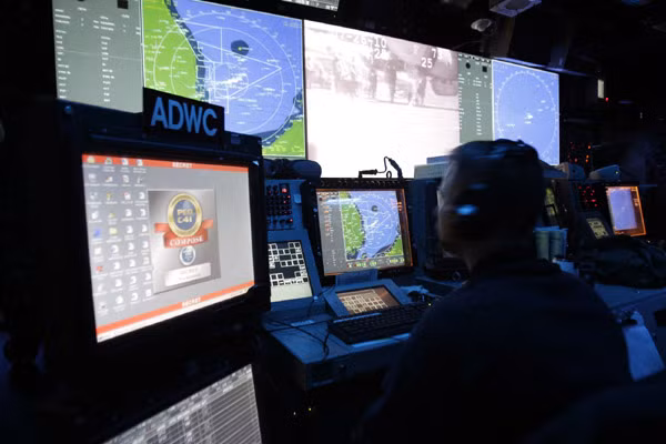 A crew member of the Nimitz-class USS George Washington works at the Combat Defense Centre