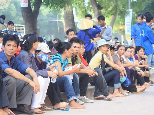 Các phụ huynh ngồi chờ con em mình trước điểm thi Đại học KHXH&NV. Ảnh, gdtd.vn