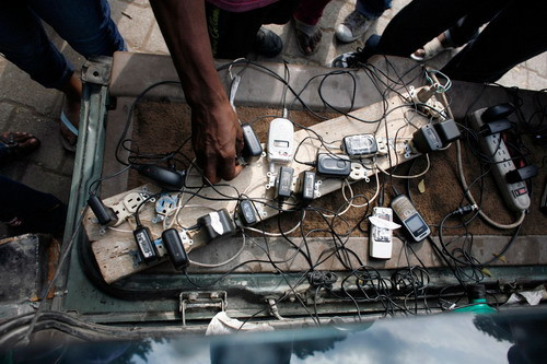 A man rents mobile phone chargers by the hour in downtown Port-au-Prince January 17,