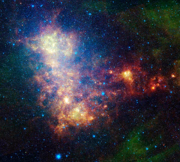 An infrared portrait of the Small Magellanic Cloud, taken by NASA’s Spitzer Space Telescope. The image shows both old stars and young stars, a galactic globular cluster and emission from dust in our own galaxy