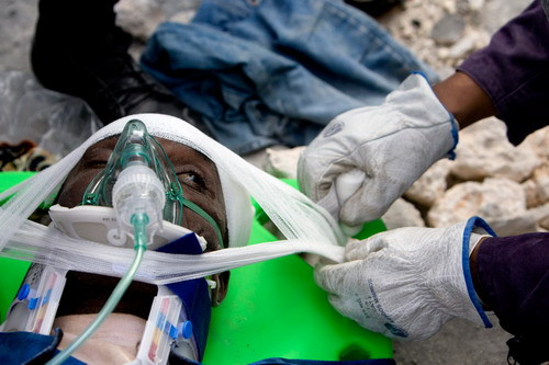 A man is rescued by members of U.S., Spanish and Taiwanese rescue teams in Port-au-Prince, Haiti, January 17