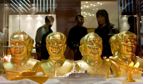 Gold busts of (l-r) Chinese leaders President Hu Jintao, former president Jiang Zemin, late patriarch Deng Xiaoping and Mao Zedong, are displayed at a gold exhibition in Beijing, China on November 8, 2009