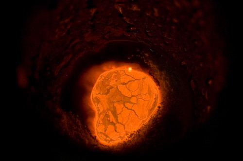 Molten gold and flux used to remove impurities glows red hot as it is melted in an induction melting machine at Dvir & Stoler Refining in New York, U.S