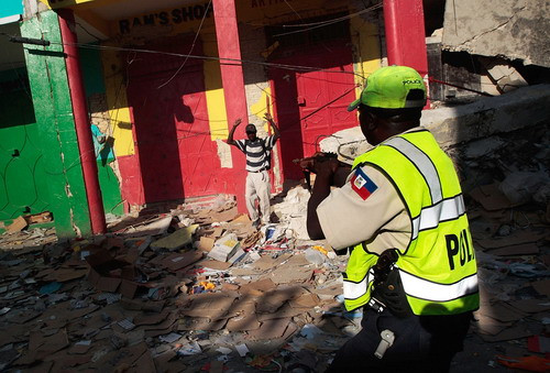 Looters fight for goods outside a grocery store on January 17, 2010 in Port-au-Prince, five days after a massive earthquake devastated Haiti’s infrastructure and killed tens of thousands of people