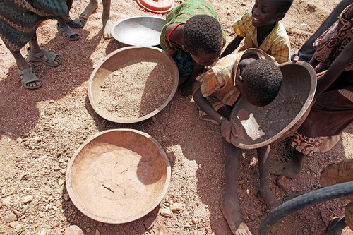 Villagers use tools to pan for gold from the Irrawaddy river near Bahalminhtin Bridge near the town of Myitkyina in the northern Myanmar on January 7, 2010.