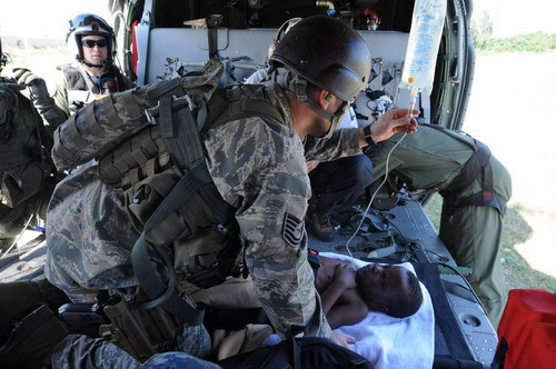 Scavengers climb across the rubble of quake-damaged buildings in downtown Port-au-Prince, Sunday, Jan. 17, 2010. Haitian police scattered hundreds of stone-throwing looters.