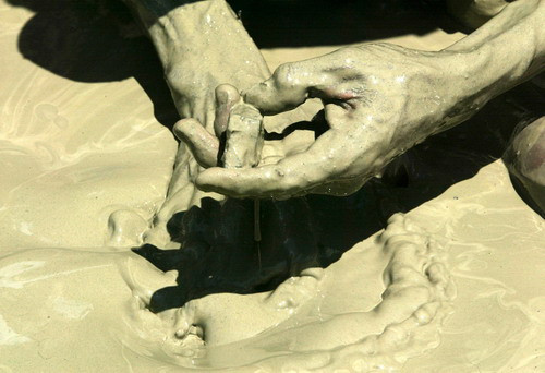 A villager looks for gold dust from sand along a river at Pidie district, Indonesia’s Aceh province 