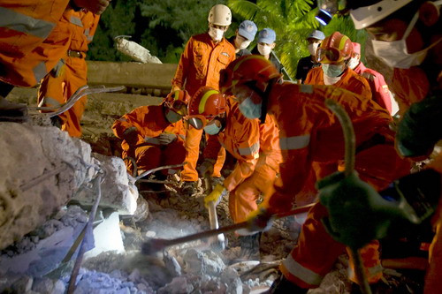 A Brazilian and Chinese search and rescue team searches through the rubble of the headquarters of the United Nation’s mission in Haiti in Port au Prince January 15, 2010.