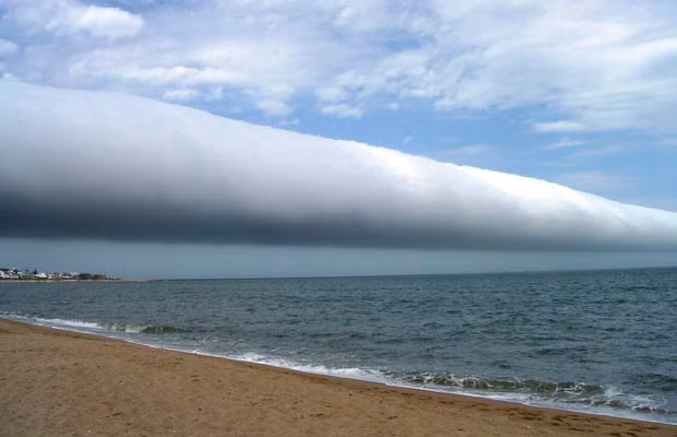 A roll cloud extends far into the distance above Las Olas Beach in Maldonado, Uruguay