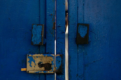 Haitians survey the damage to a building that collapsed onto a road in downtown Port-au-Prince