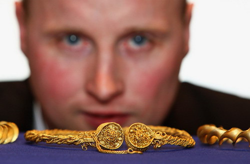 Metal detector enthusiast David Booth poses with his hoard of Iron Age Gold on November 4, 2009 in Edinburgh, Scotland. Booth discovered the gold Iron Age torcs buried on on private land in Stirlingshire - the items dating from between 300-100 BC. The hoard is currently under protection of the Treasure Trove Unit, under Scottish law, the Crown can claim any archaeological objects found in Scotland.