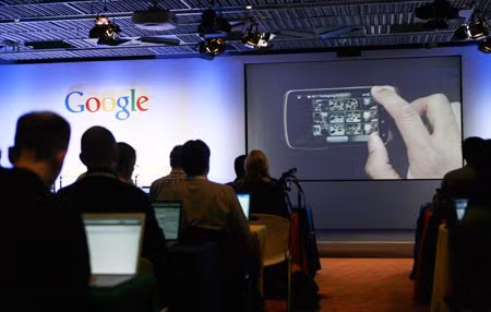 Media attending the unveiling of the Nexus One smartphone, using the Android platform, watch an application on the first mobile phone the internet company will sell directly to consumers, during a news conference at Google headquarters in Mountain View, California January 5, 2010.