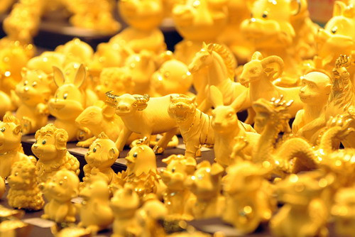 Gold figurines on display in a shop window in Hong Kong