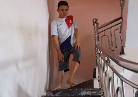 Chang trai khuyet tat thoi hon vao nhung hat gao - Anh 1