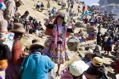 An Andean girl gets ready for her performance during celebrations of the construction of the Qeswachaka hanging bridge