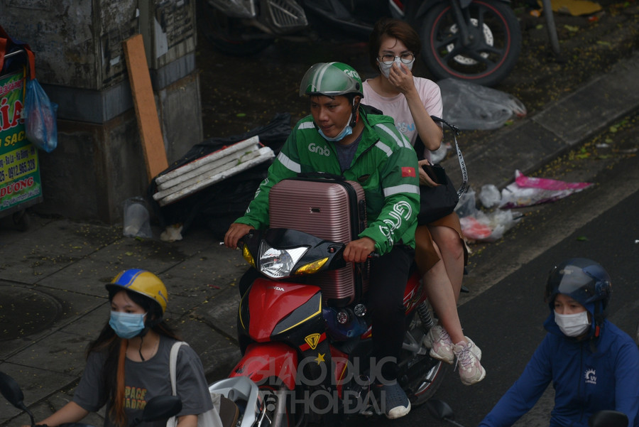 Nhiều người lích kích đồ đạc đi chuyển ra bến xe.