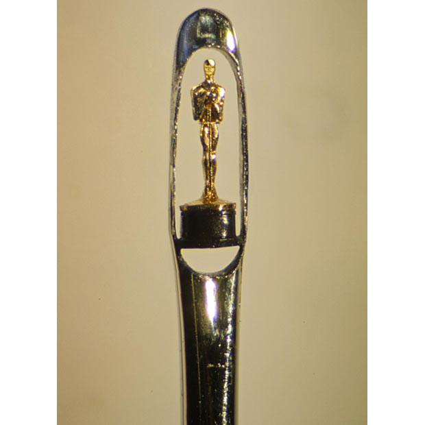 Sculptor Willard Wigan from Birmingham has carved the Oscar award out of a speck of 22-carat gold using just a shard of diamond and a microscope. 