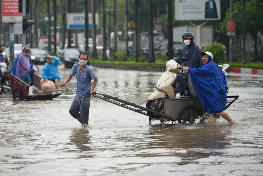 Chỉ sau vài tiếng đồng hồ, những người làm dịch vụ chở xe qua điểm úng ngập có thể kiếm được hàng triệu đồng.