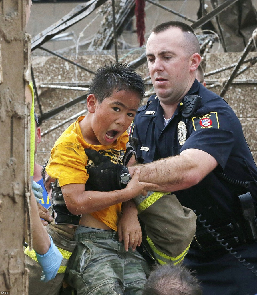 Brave: A boy is pulled from beneath a collapsed wall at the Plaza Towers Elementary School following a tornado in Moore, Oklahoma Read more: http://www.dailymail.co.uk/news/article-2328000/US-tornadoes-Yet-heartbreak-Oklahoma-massive-tornado-touches-highly-populated-suburb.html#ixzz2TtNNBCOI Follow us: @MailOnline on Twitter | DailyMail on Facebook