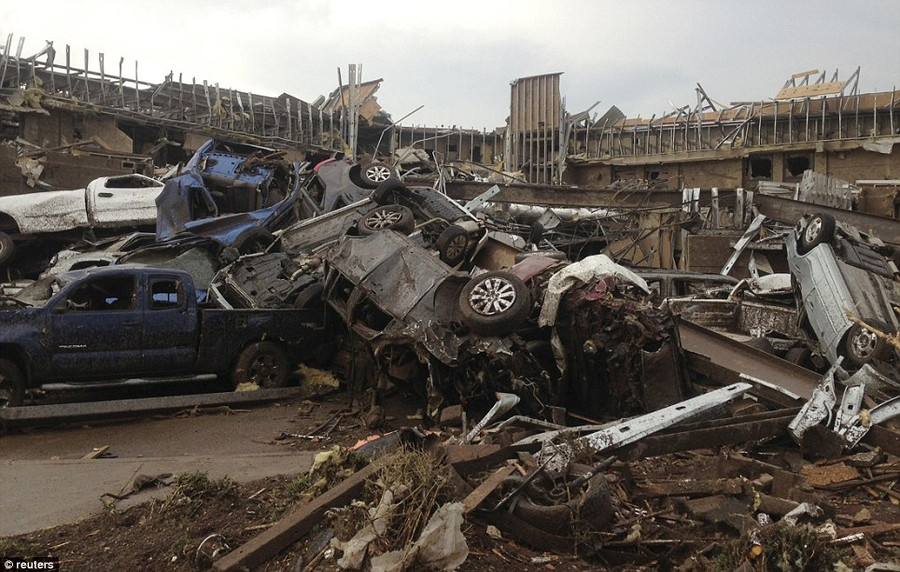 Overturned cars are seen after a huge tornado touched down in the town of Moore Read more: http://www.dailymail.co.uk/news/article-2328000/US-tornadoes-Yet-heartbreak-Oklahoma-massive-tornado-touches-highly-populated-suburb.html#ixzz2TtNioJeY Follow us: @MailOnline on Twitter | DailyMail on Facebook
